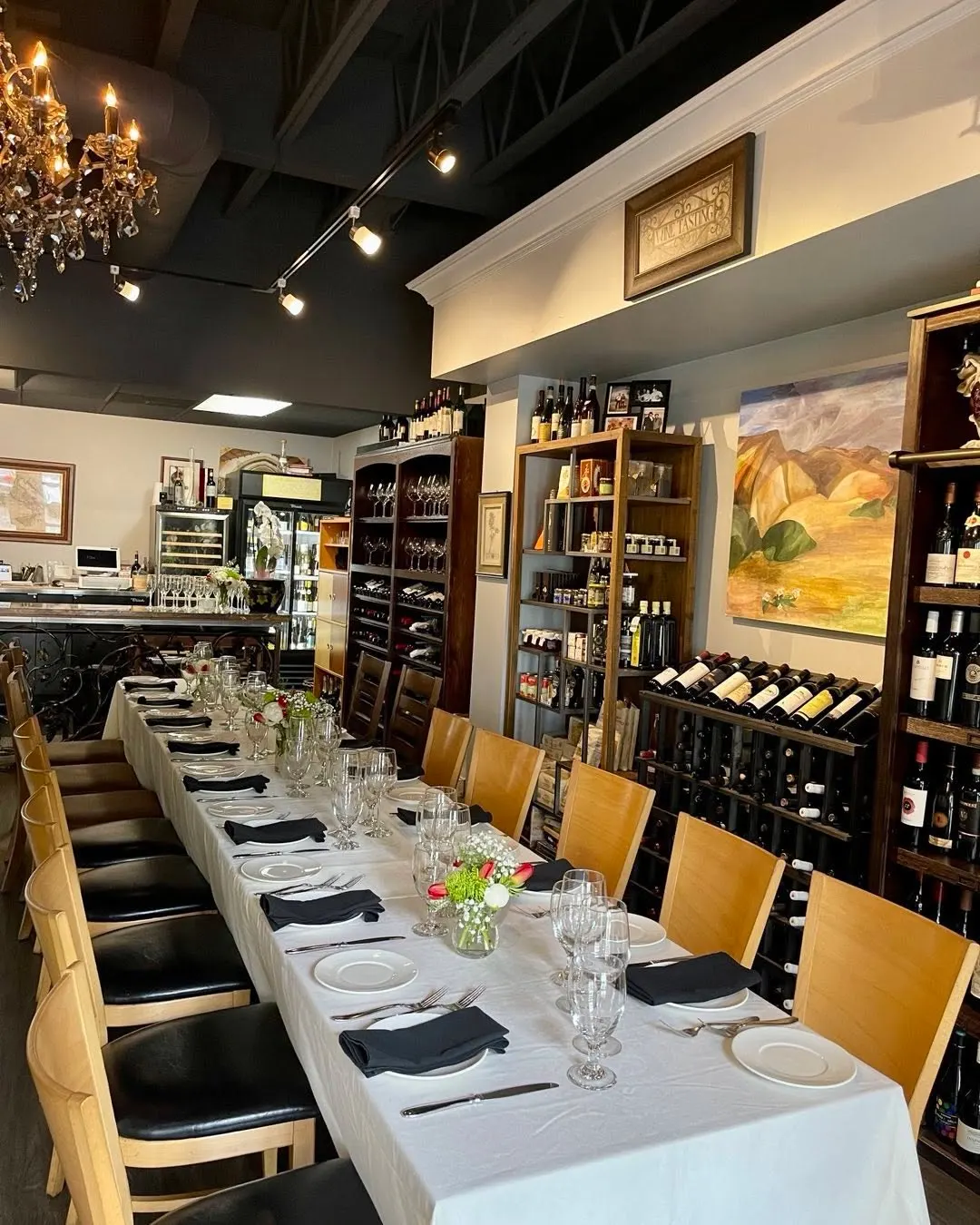 Private dining table set with white linens, wine glasses, and napkins at Onotria